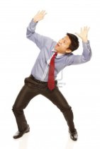 15192654-a-man-in-shirt-and-tie-acting-afraid-of-being-crushed-on-white-background